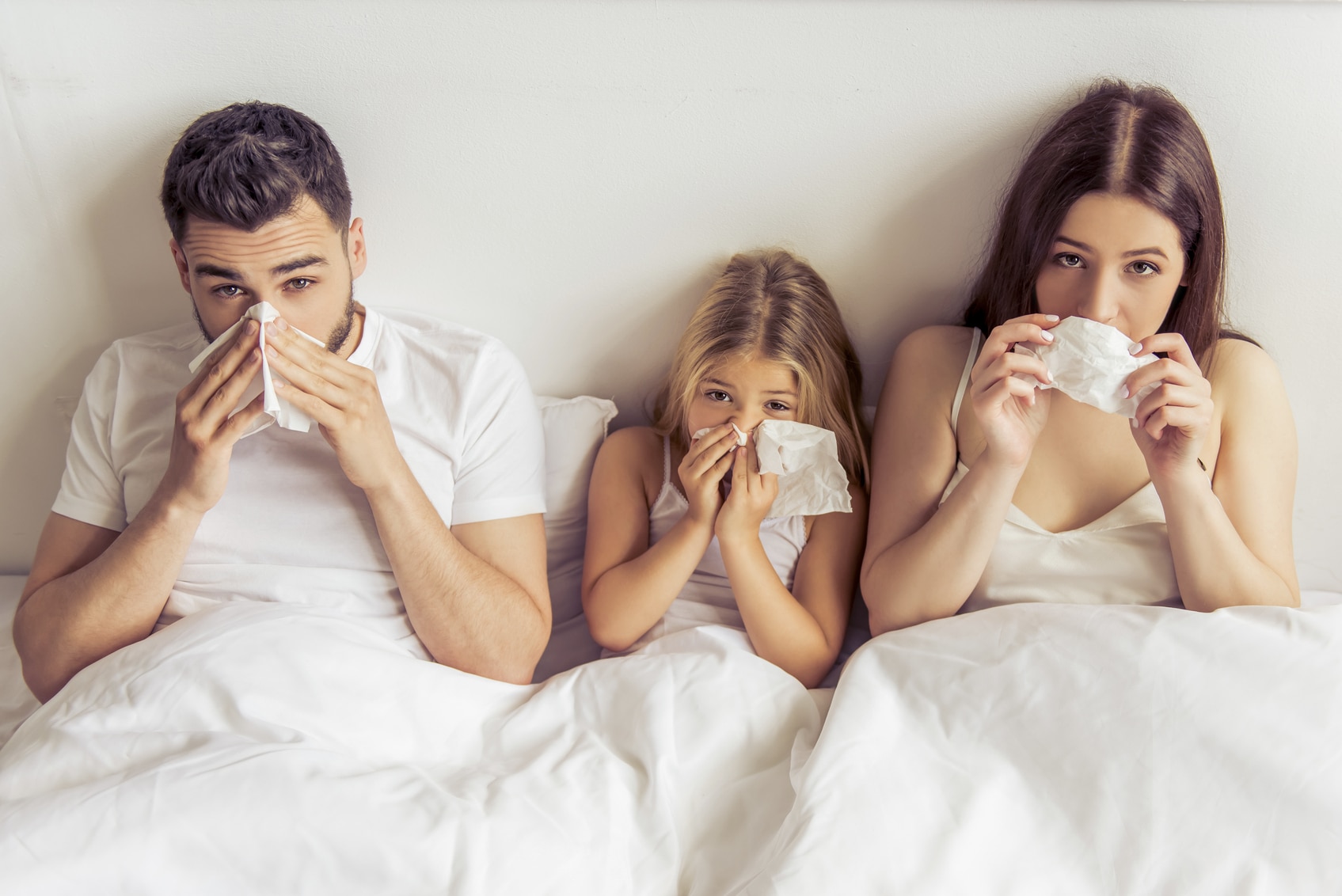 Family sick in bed with cold